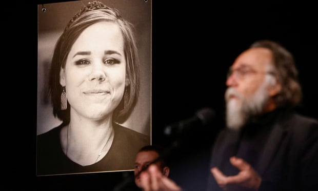 Alexander Dugin, the father of Darya Dugina, speaks at her funeral beside a picture of his daughter. Photograph: Maxim Shemetov/Reuters