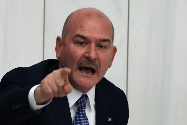 Turkey's Minister of Interior Suleyman Soylu argues with opposition MPs during budget negotiations in parliament on 10 December 2022 (AFP)
