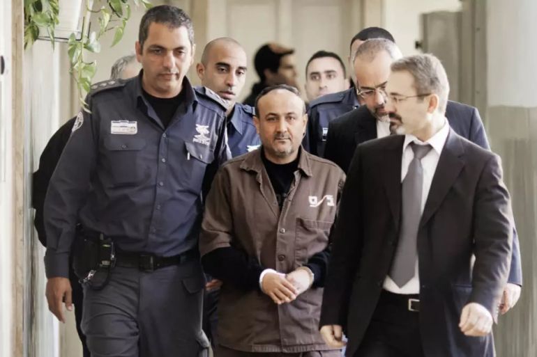 Palestinian Fatah leader Marwan Barghouti is escorted by Israeli police into Jerusalem's magistrate court, on 25 January 2012 (Marco Longari/AFP)